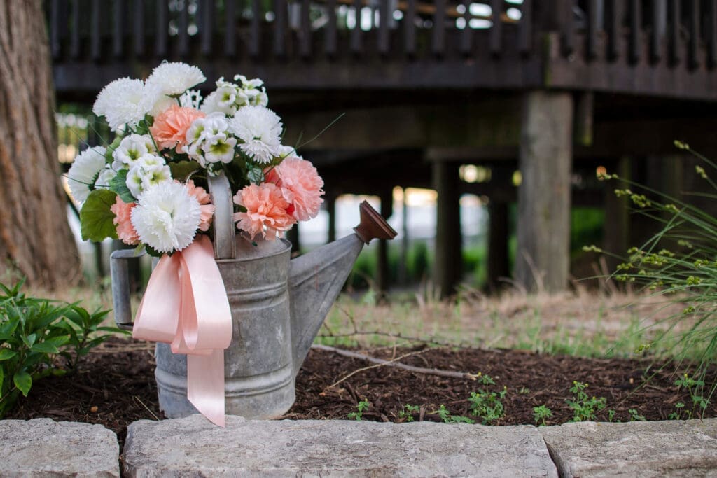 Flowers in a garden water can used as wedding decoration