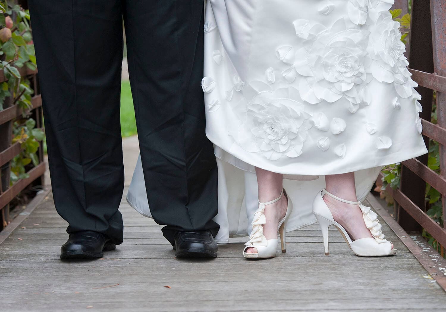 Wedding couple shoes on a bridge.