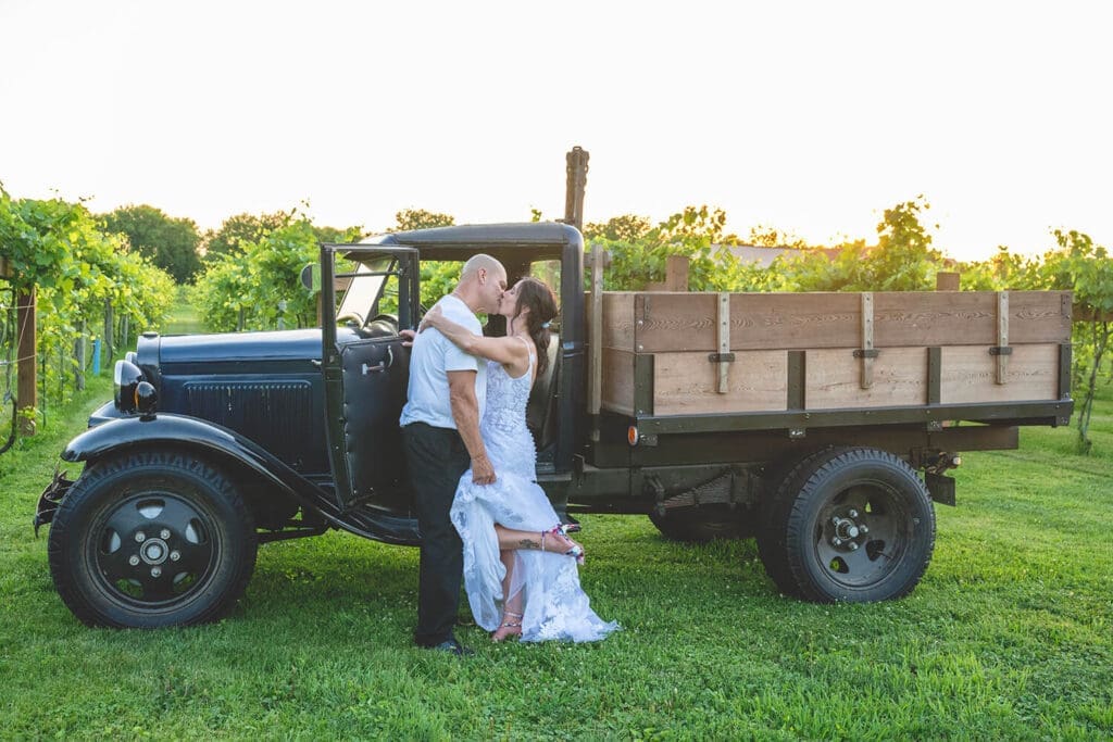 Wedding couple Jeff and Kerri embrace in a vineyard during their wedding