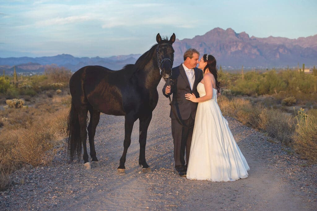 wedding couple Tyler and Karen pose with a horse on their wedding day