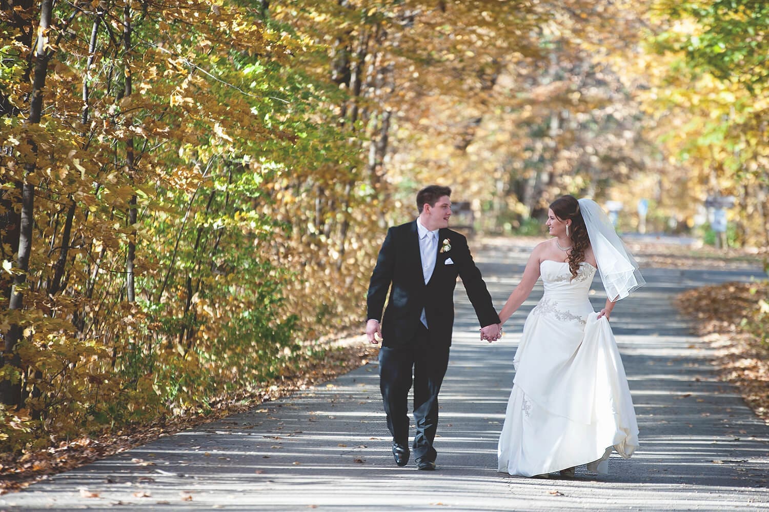 Wedding couple walk down lane in Oregon, IL