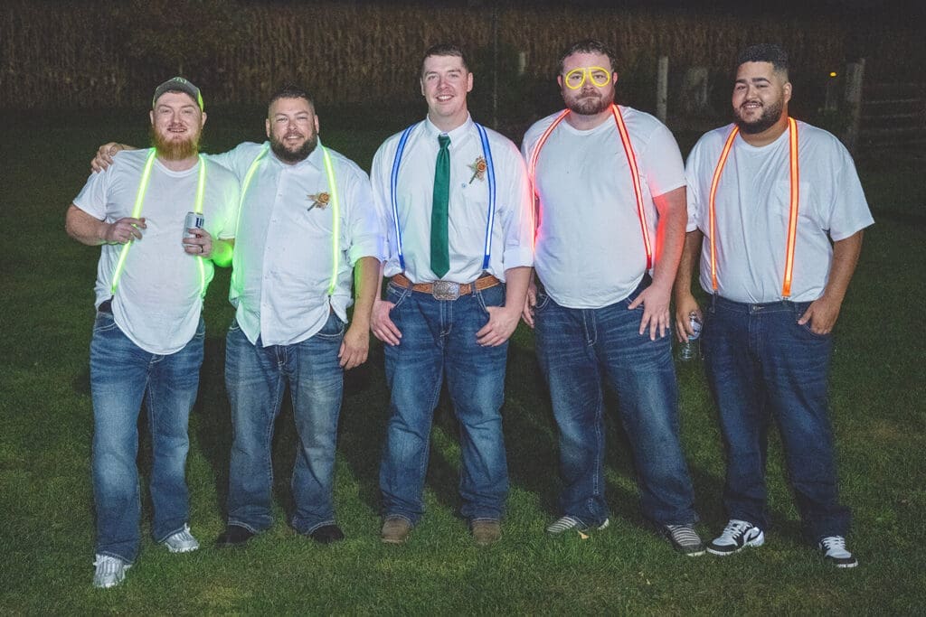 Groom and groomsmen wear matching light up suspenders