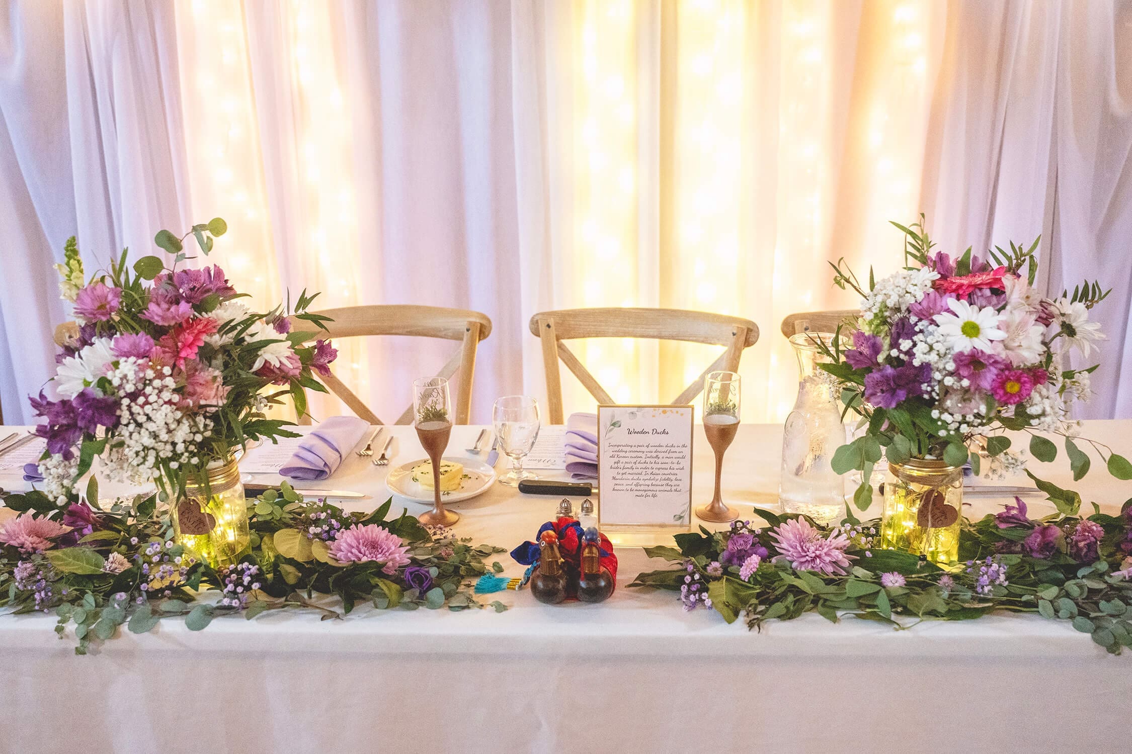 Wedding reception head table in the barn at Midway Village