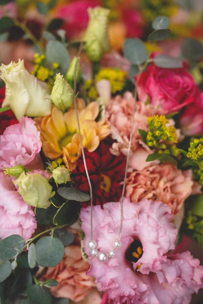 bride's necklace on bridal bouquet