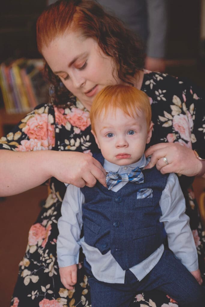 ring bearer gets bowtie adjusted