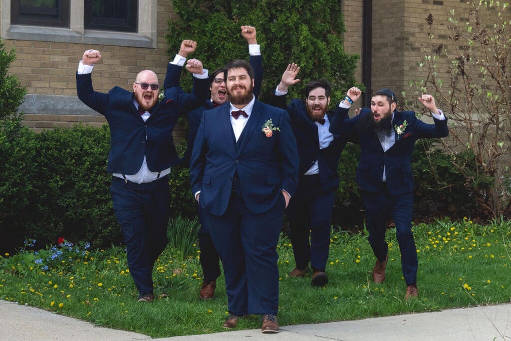 groomsmen pose for wedding portraits