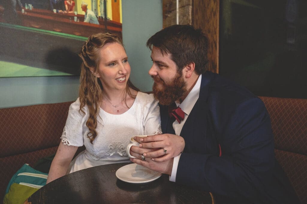 bride and groom share coffee