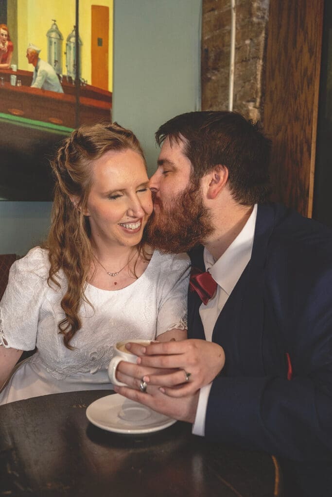 groom kisses brides cheek