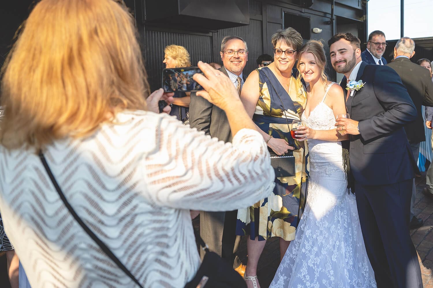Wedding couple take photos with guests at The Standard in Rockford, IL