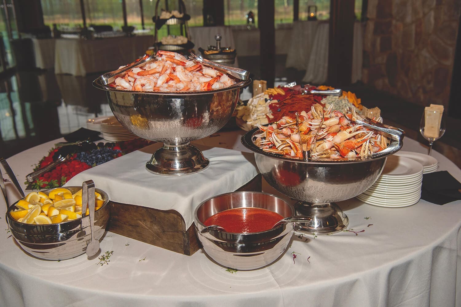 Platters of shrimp displayed at a wedding reception.