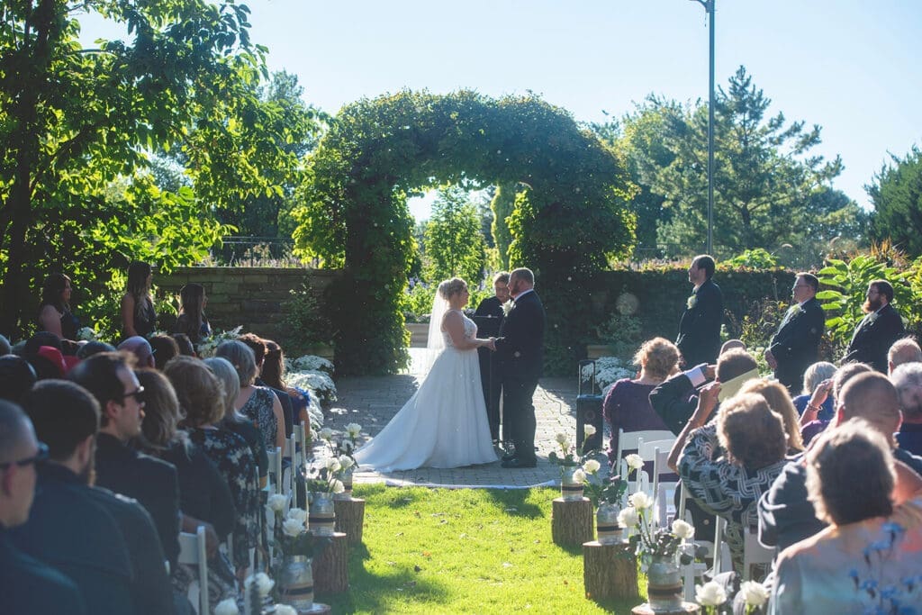 Wedding ceremony performed outside at Janesville Rotary Garden in Janesville, WI