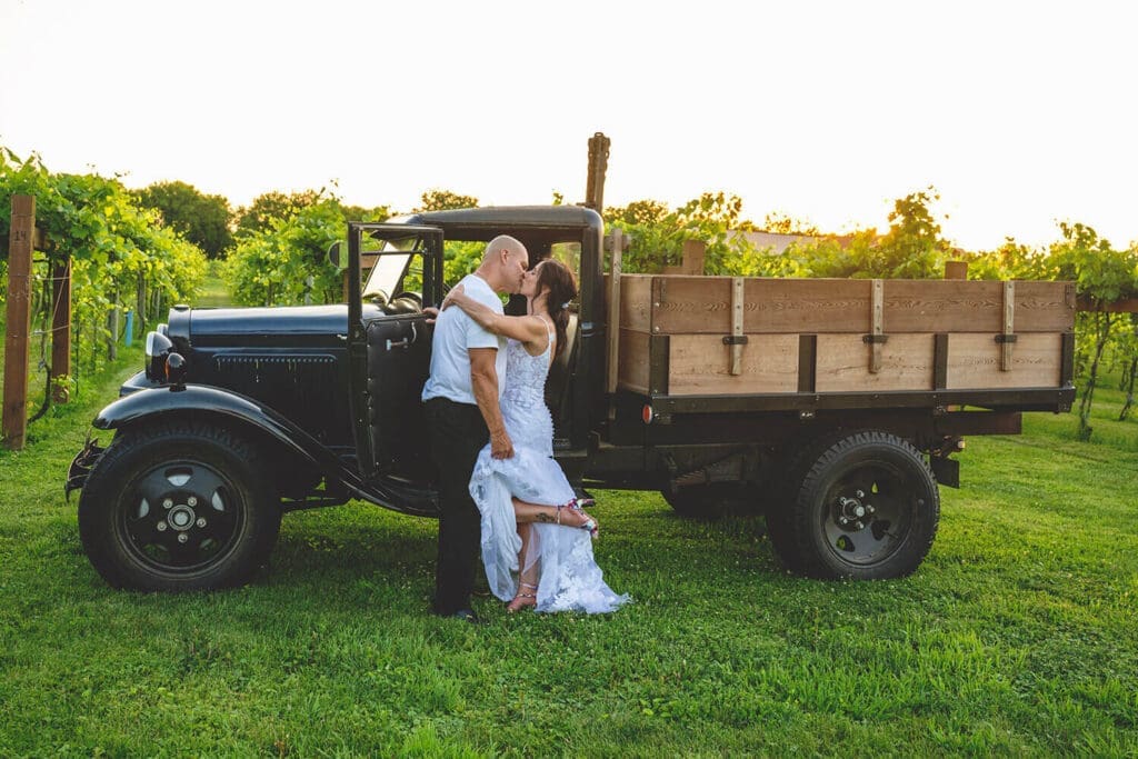 Jeff and Kerri pose in front of the vintage truck and vineyard at DC Estate Winery in South Beloit, IL