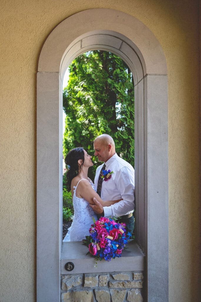 Kerri and Jeff embrace near the entrance of at DC Estate Winery in South Beloit, IL during their wedding