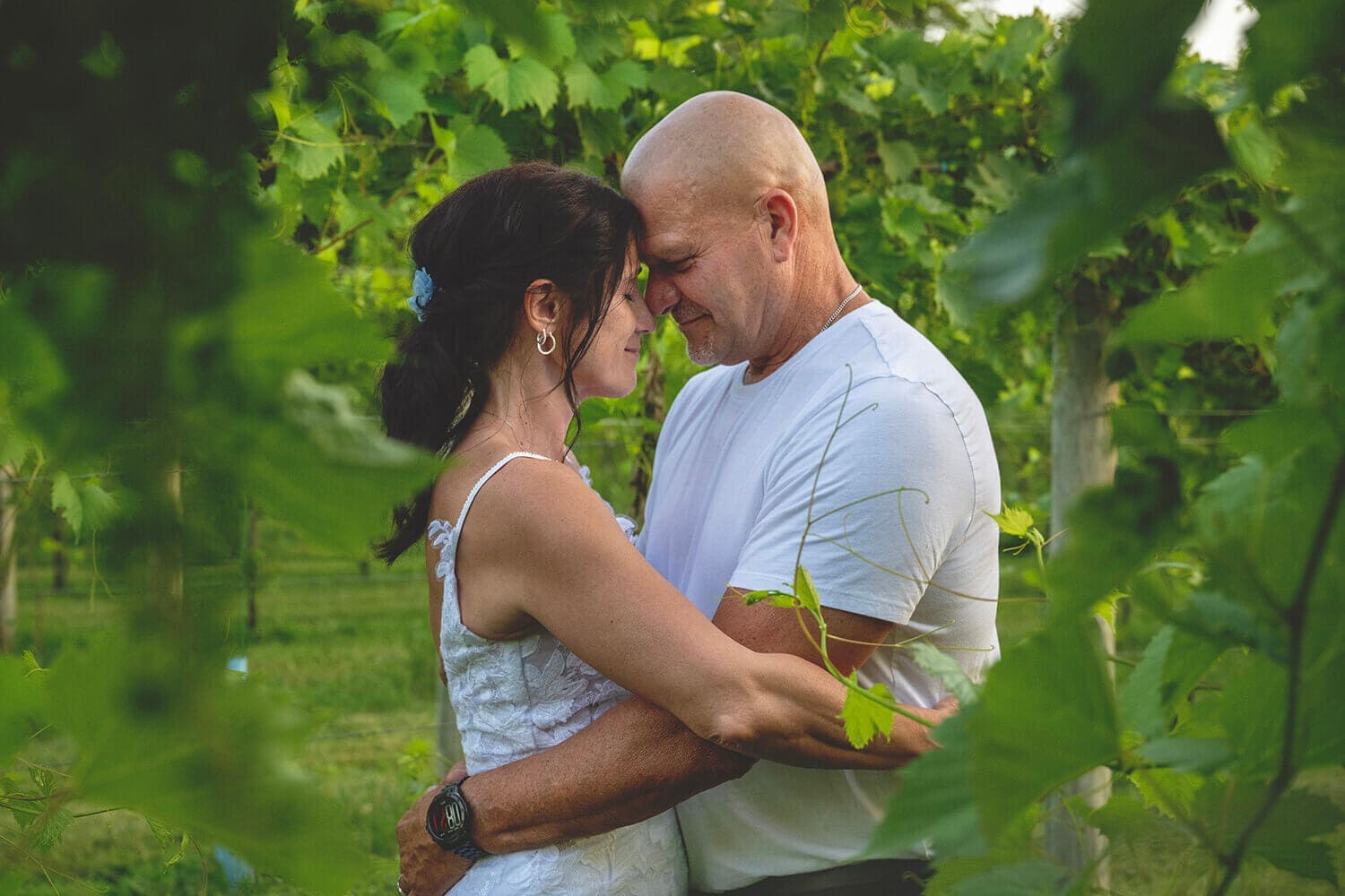 Kerri and Jeff pose in the vineyards during their wedding at DC Estate Winery in South Beloit, IL
