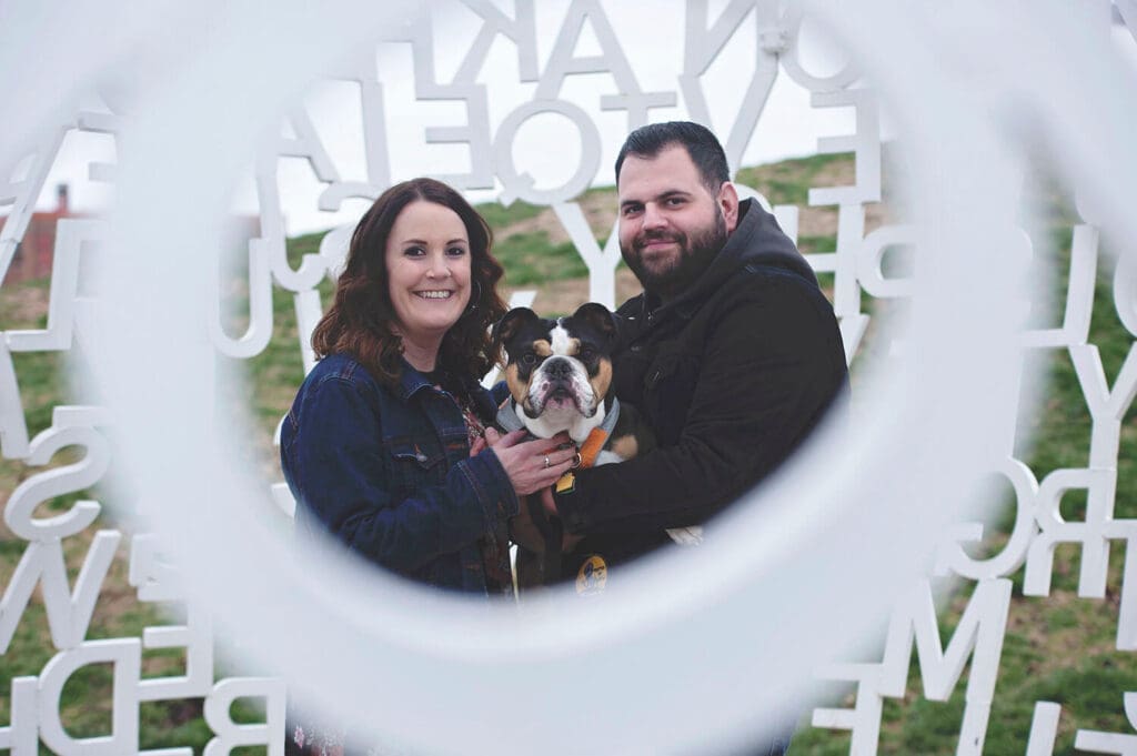 Engaged couple take photos with dog Charlie in Des Moines, IA