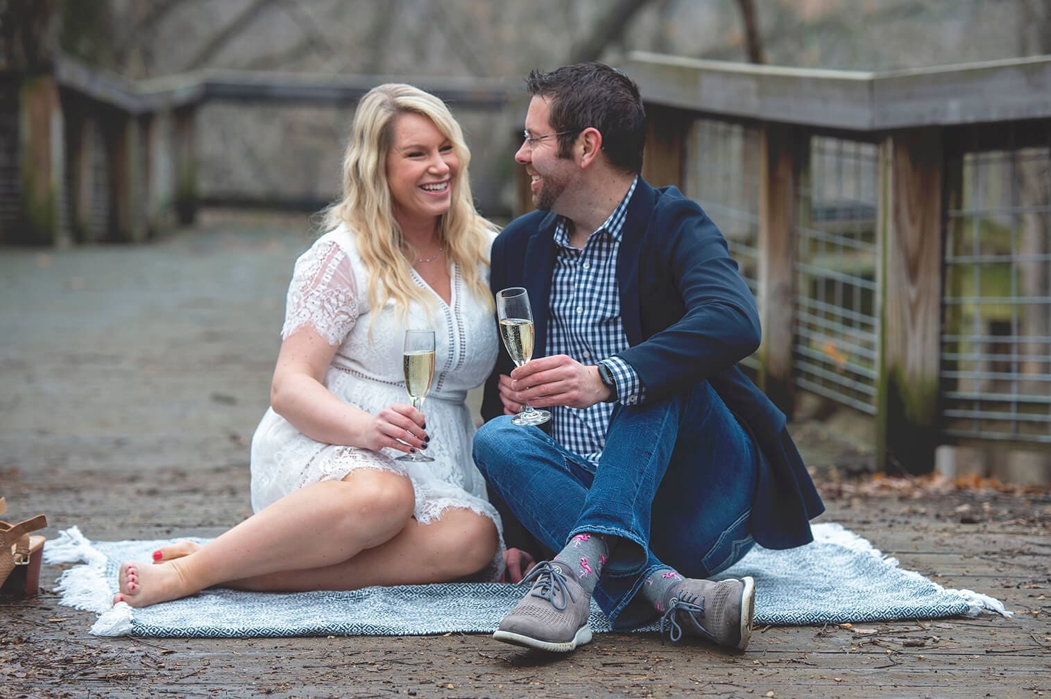 Chase and Brittany toast champagne for their engagement at Rock Cut State Park in Caledonia, IL