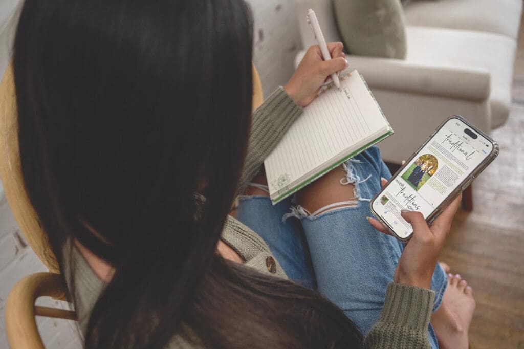 Woman takes notes while reading wedding advice guide from phone