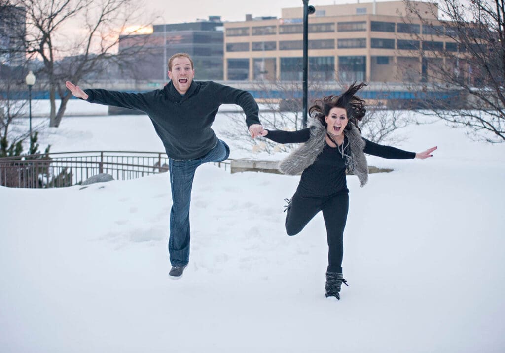 Engaged couple take fun photos in the snow in downtown Rockford, IL