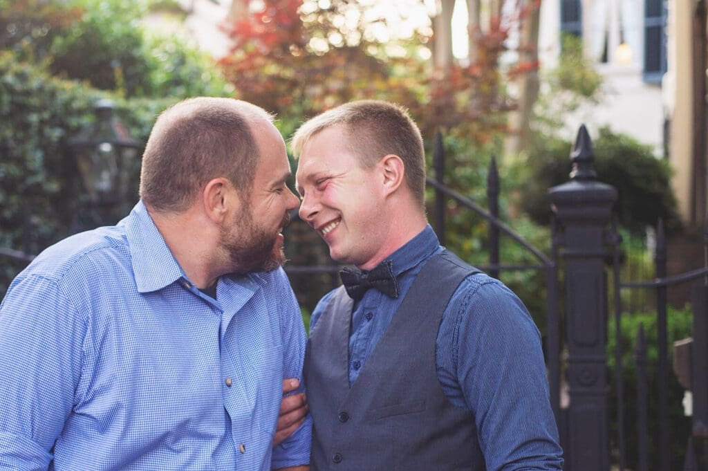 Two engaged men take photos in New Orleans, LA