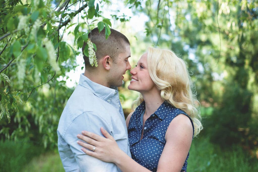 Engaged couple takes engagement photos outdoors in spring